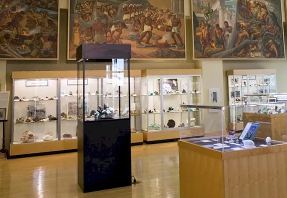 Display cases with gems & minerals, painting of the history of mining
