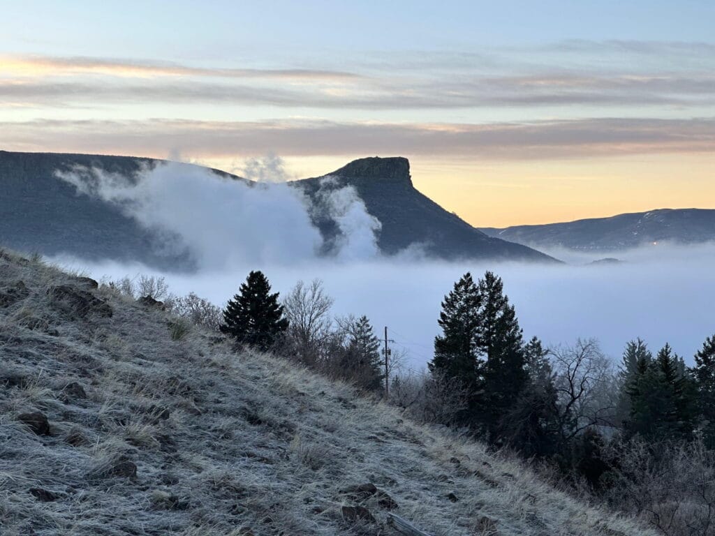 Castle Rock looming above fog in the Clear Creek valley - Golden Colorado