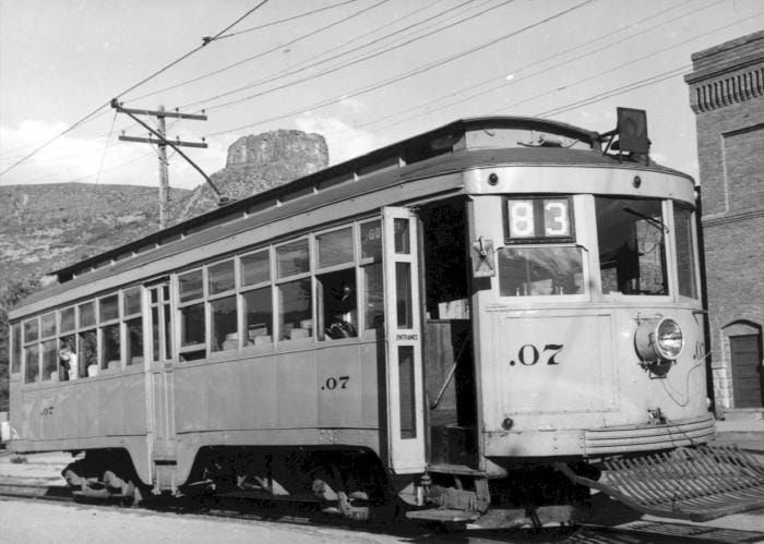 Denver and Intermountain electric car and 13th and Washington, with Castle Rock in the background