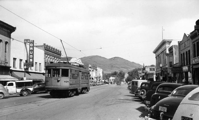 Trolley car traveling down Washington Avenue.  Alpine Drug appears in the background.