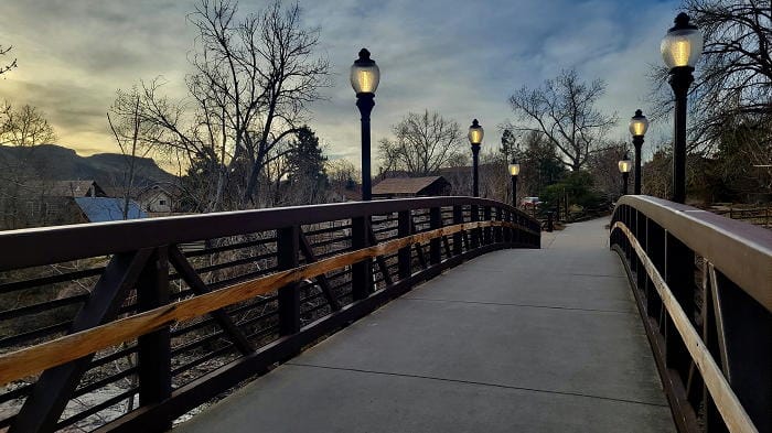 Billy Drew pedestrian bridge over Clear Creek in the morning, lights still illuminated