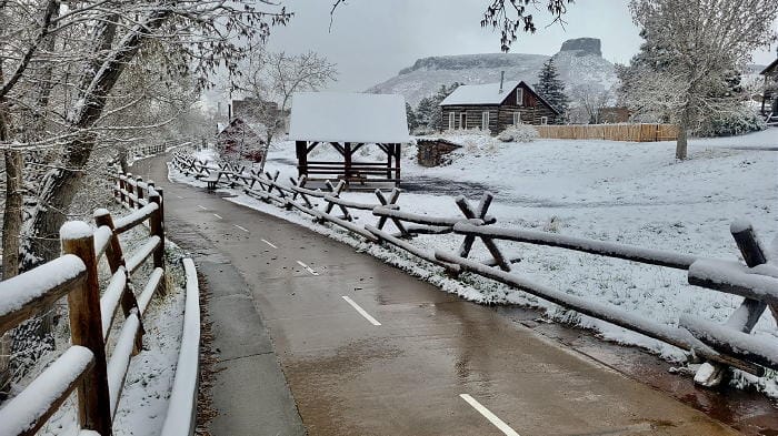 The bike and pedestrian path on the south side of Clear Creek.  The Clear Creek History Park is covered in snow and Castle Rock appears in the background.