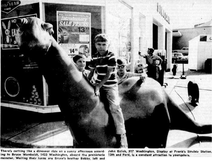 children playing on the dinosaur mascot at Sinclair gas station - Golden, CO