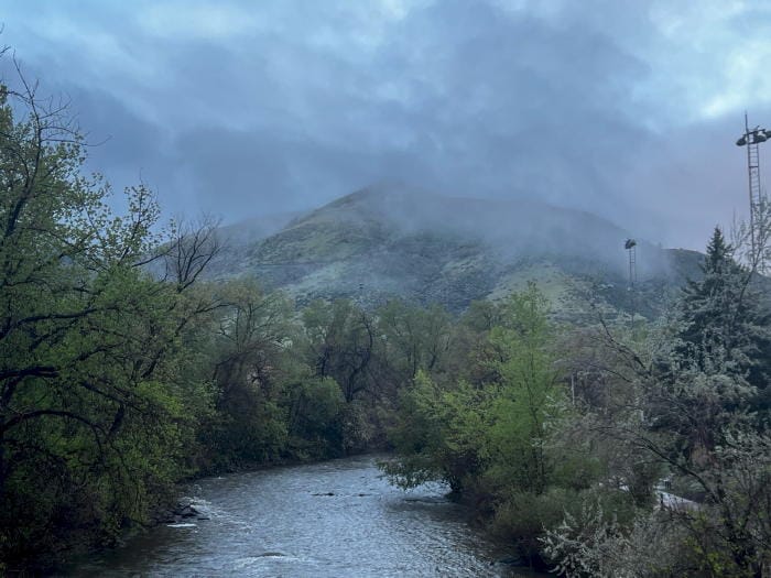 Clear Creek is the foreground, Mt. Zion in the background with low-lying clouds partly obscuring the top of the mountain.