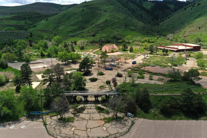 The former Heritage Square amusement park.  All but one of the buildings have been demolished, the remaining one being a large steel building.  The railroad bridge over the entrance is still intact, but the rails and ties have been removed.  The alpine slide track is overgrown.