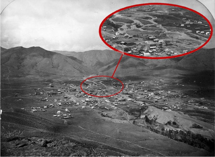 Early photo of the Golden valley, taken from Castle Rock. Clear Creek runs diagonally from left to right and disappears into Clear Creek canyon. A scattering of buildings appears along the streets.