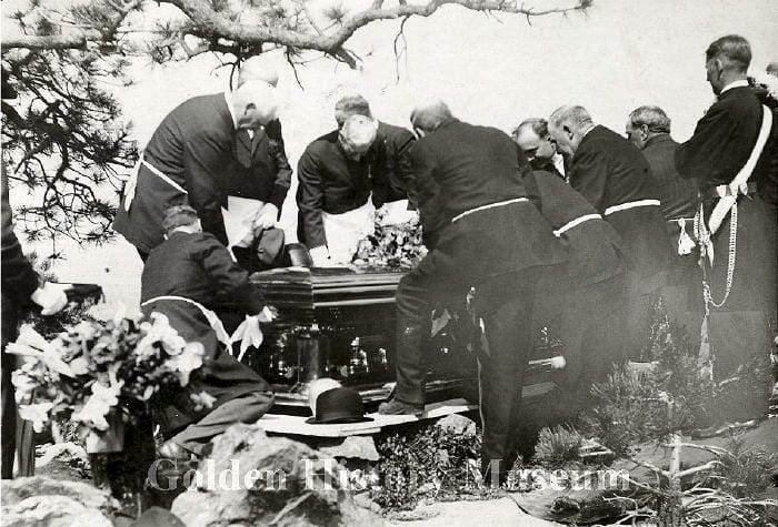 A group of men lowering the coffin of William Cody (Buffalo Bill)