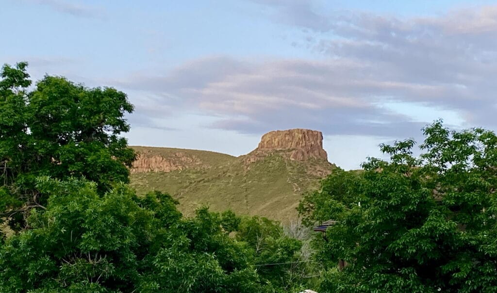 Castle Rock Looming Above a Sea of Green Leaves