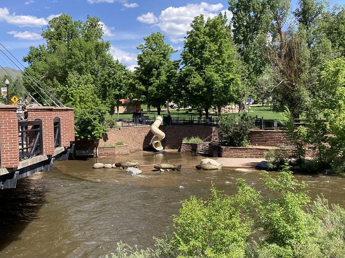 Clear Creek just east of the Washington Avenue bridge. The Creek is high with spring run-off. Parfet Park, in the background, is very green.