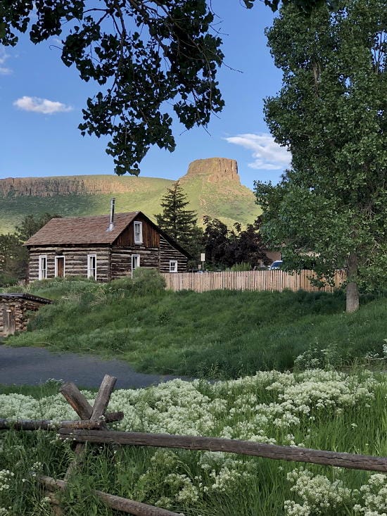 A cabin in the Golden History Park with Castle Rock in the background