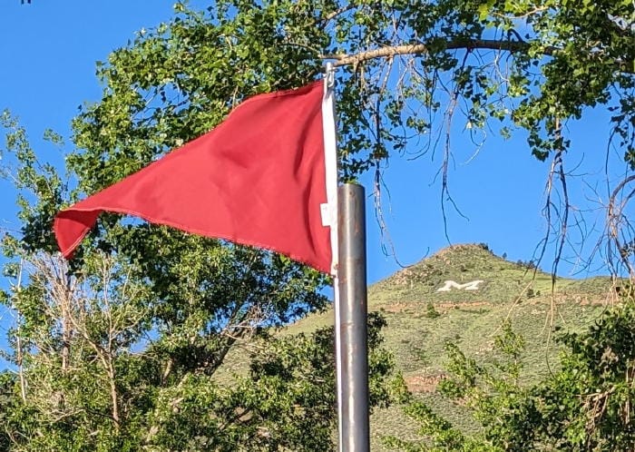 red pennant with Mt. Zion in the background