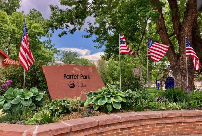 Four American flags planted in the garden at the northwest corner of Parfet Park