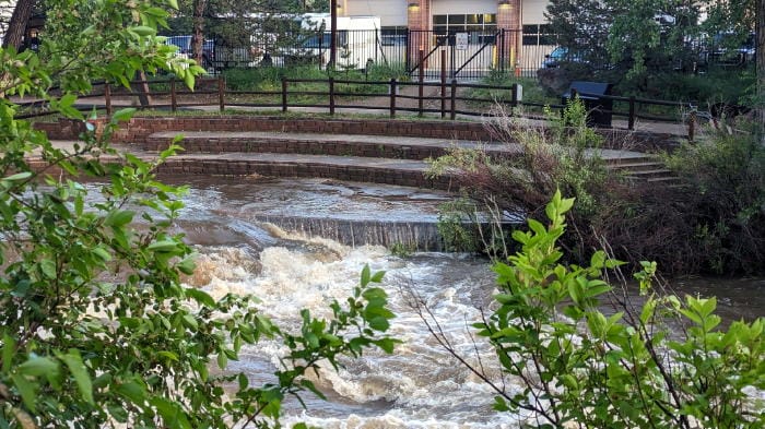 Clear Creek breaking its banks and pouring over the Rotary Amphitheater