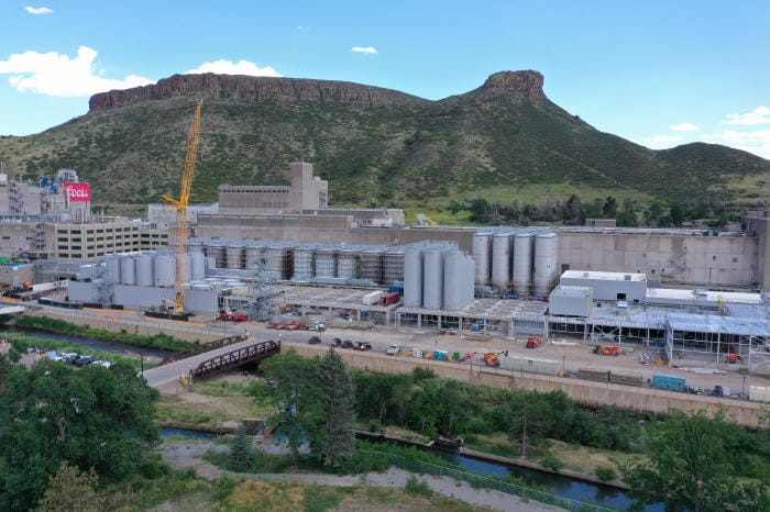 Construction underway at the Coors brewery - Castle Rock in the background