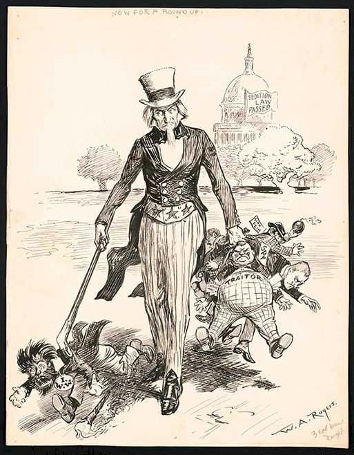 political cartoon showing Uncle Same with a man-wolf on a leash in one hand and a collection of traitors in the other