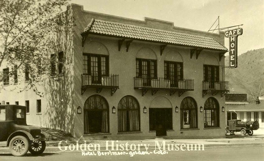 two story building with sign saying "Cafe - Hotel"