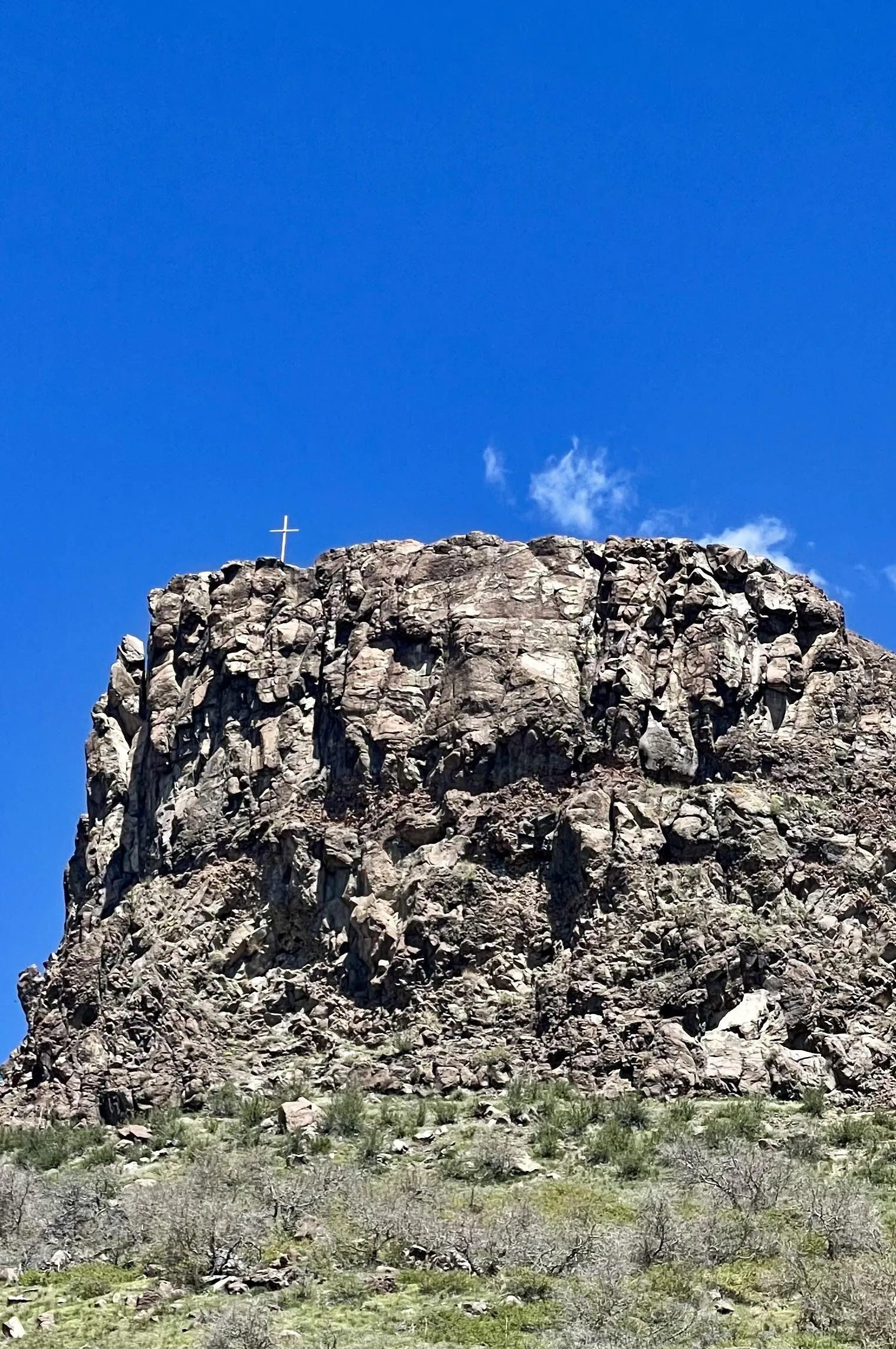 Castle Rock (a flat promotory  at the edge of South Table Mountain) with a cross planted near the edge