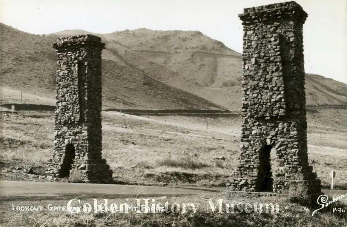 black & white postcard image of Golden's stone pillars with no buildings behind them--just the new Lariat Loop