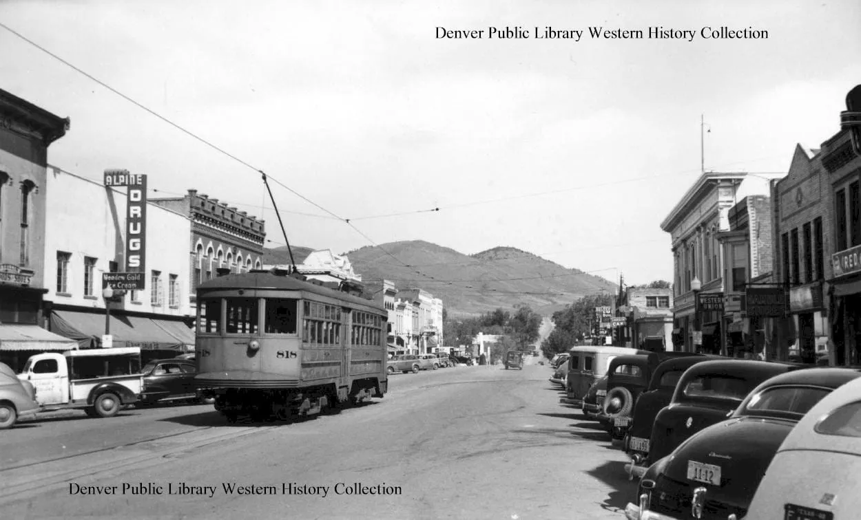 Trolley car moving down the center of Washington Avenue, 1200 block.  Alpine Drug sign on left side of picture.