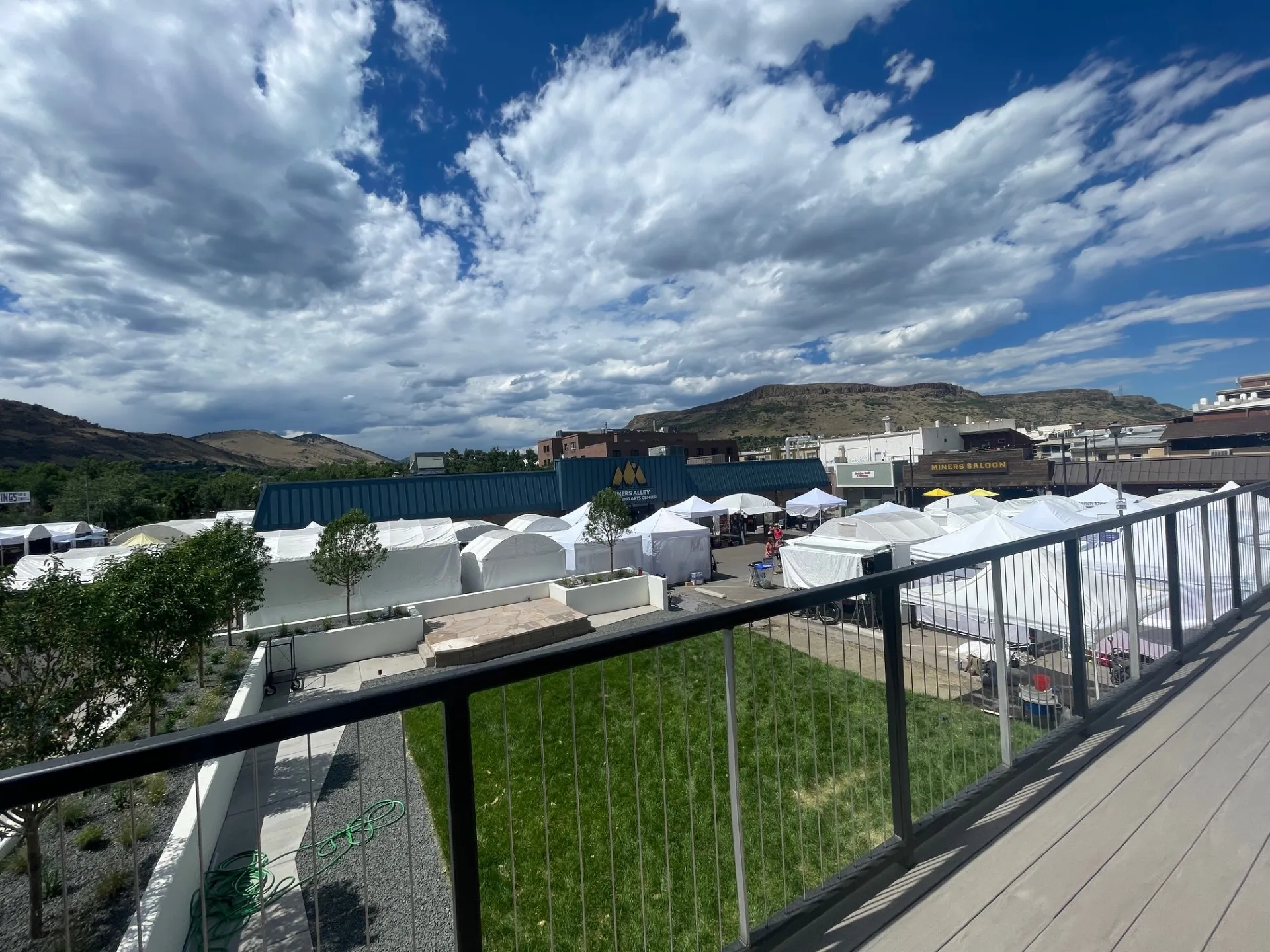 view over the white booths of the arts festival - Miners Alley Playhouse and Miners Saloon in the frame