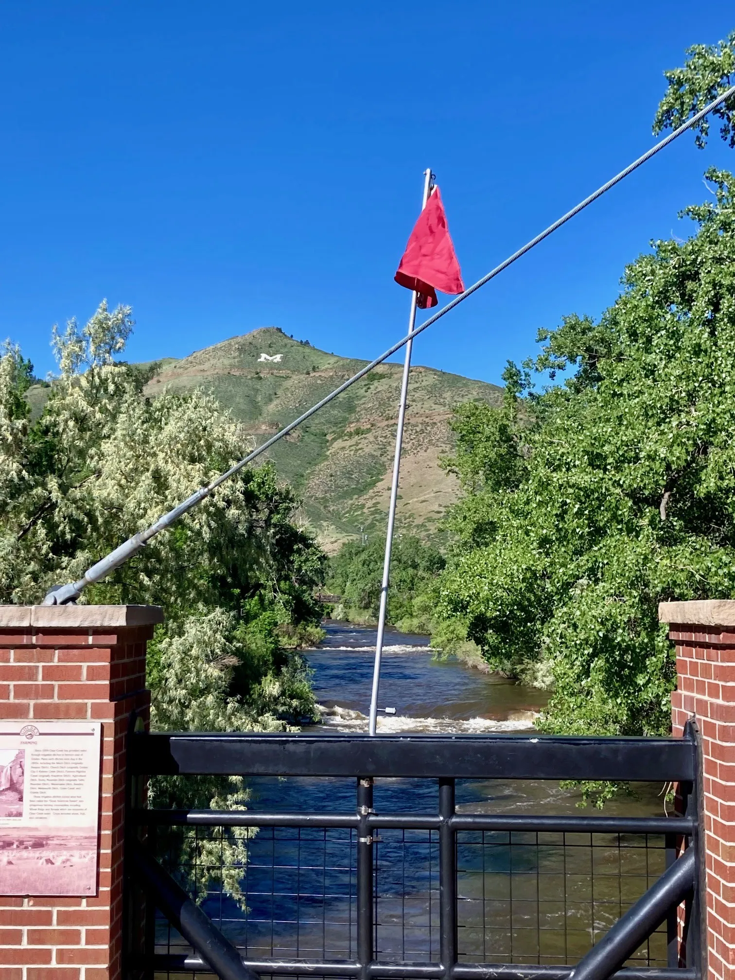 Red flag hanging on the Washington Avenue bridge above Clear Creek.  Mt. Zion in the background