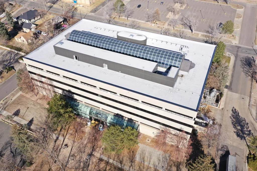 aerial view of a 4-story office building with glass over a central atrium