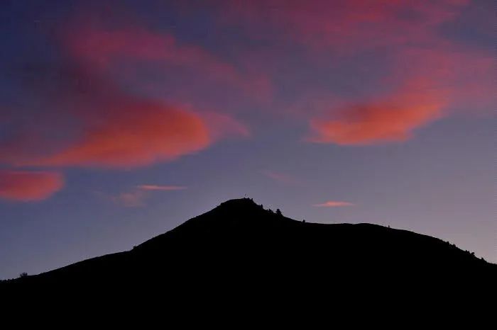 silhouette of Mount Zion against a sunset sky - the usual illuminated M is missing