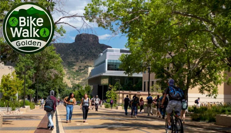 pedestrians and a cyclist on the School of Mines campus - Castle Rock in the background