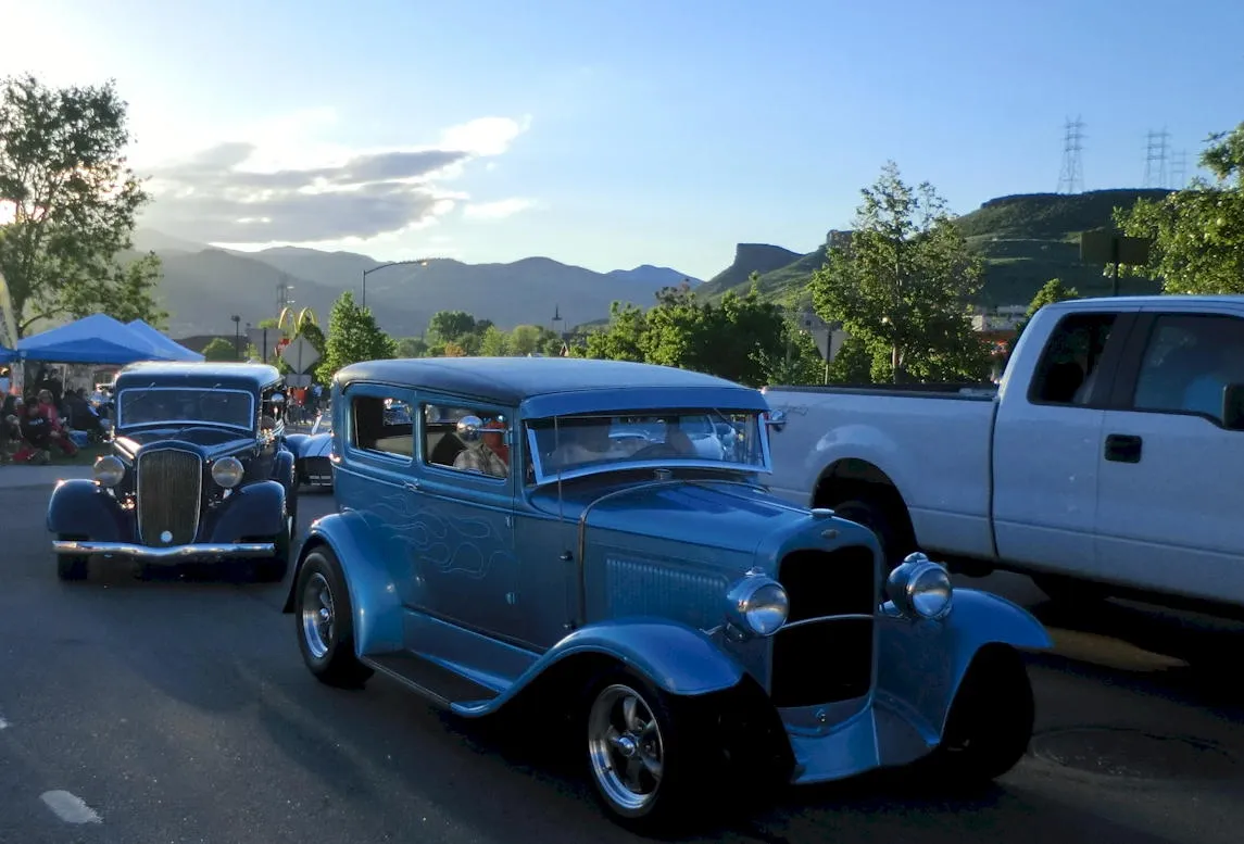 classic cars in evening light, with South Table Mountain and the foothills in the background