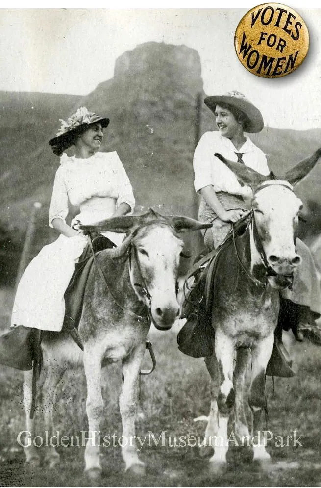 black and white image showing two women on burros with Castle Rock in the backgroun