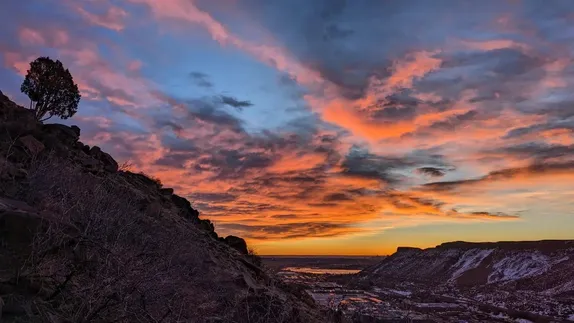 Brilliant red clouds over the Clear Creek Valley. The sun is about to appear over the horizon.