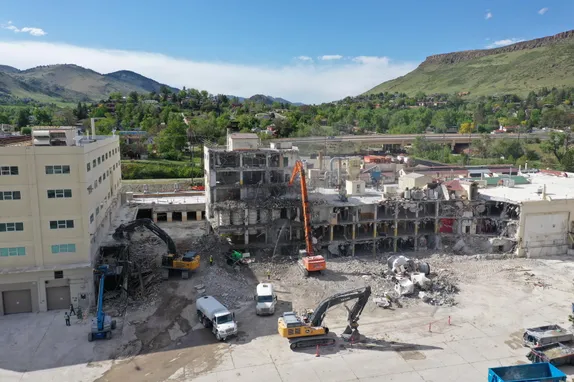 Cranes pulling down industrial buildings