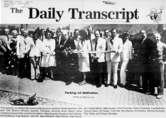 Crowd of people with a ribbon and scissors standing on a paved surface