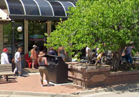 woman using a recycling bin at 12th and Washington