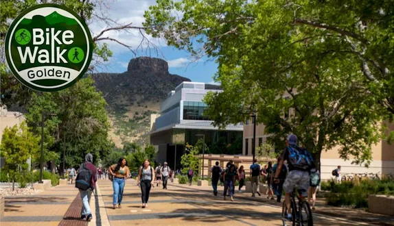 pedestrians and a cyclist on the School of Mines campus - Castle Rock in the background