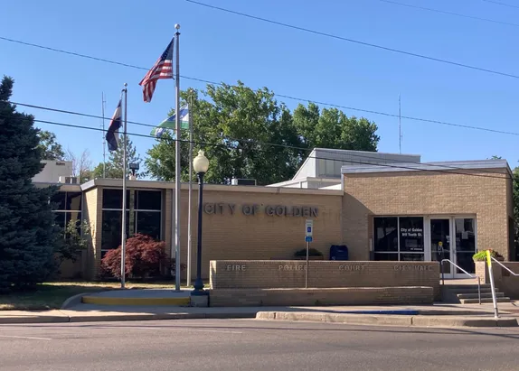 photo of Golden City Hall with American and Colorado flags on poles