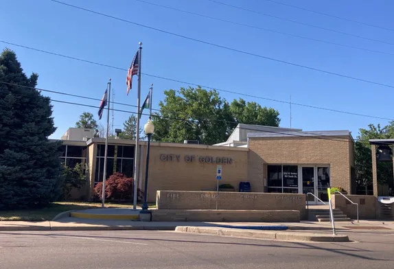 Golden city hall - brick building with flags flying