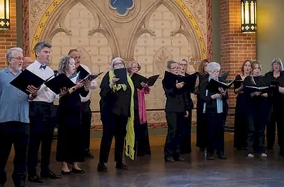 group of people singing in what appears to be a church