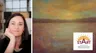 woman with long brown hair on left side, painting of sunset on right side